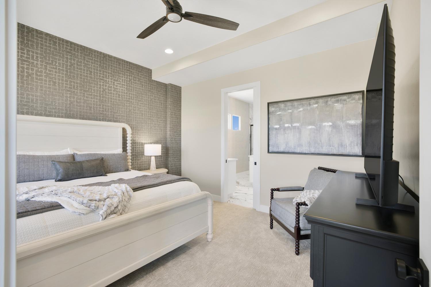 Bedroom featuring an accent wall, ceiling fan, recessed lighting, light colored carpet, and connected bathroom