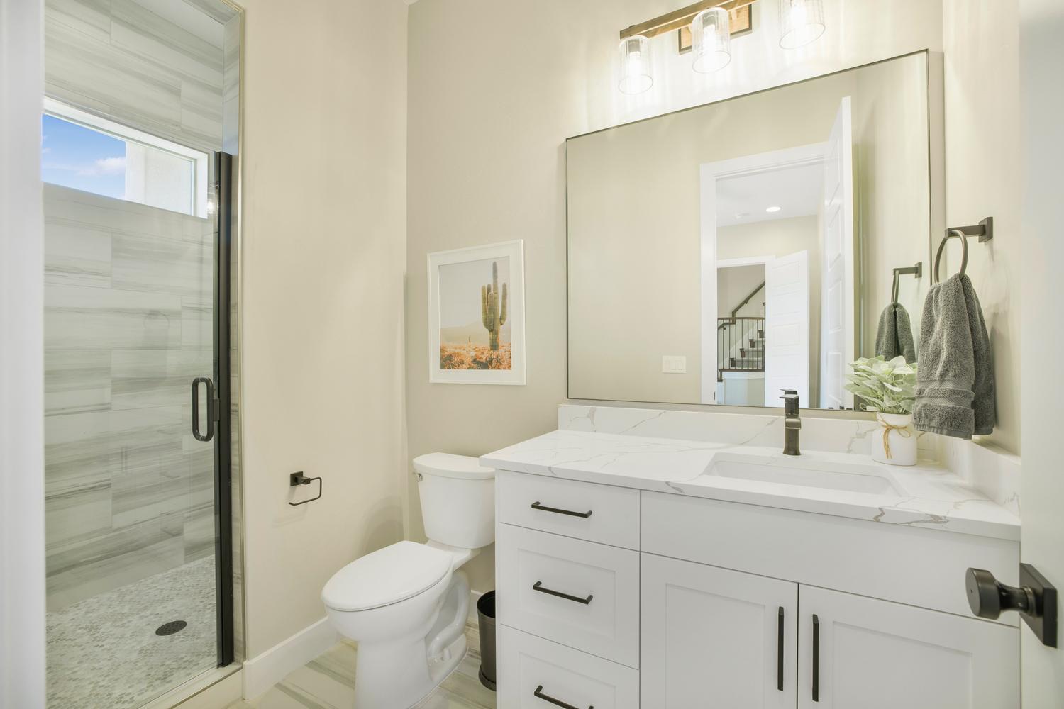Full bathroom with vanity and a stall shower