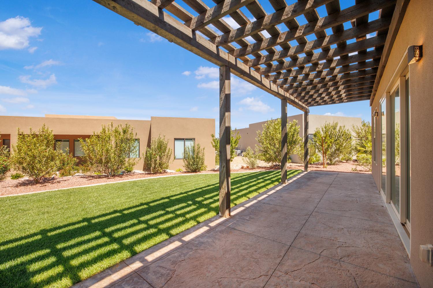 Fenced backyard featuring a pergola and a patio area