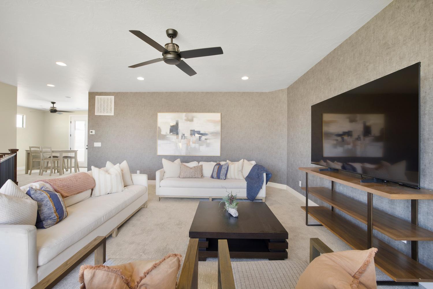 Living room with light carpet, ceiling fan, and recessed lighting