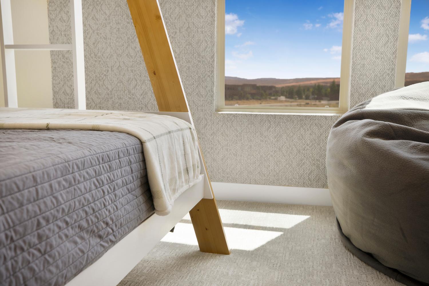 Bedroom featuring wallpapered walls and carpet