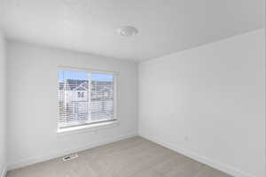 Unfurnished room with light colored carpet and baseboards