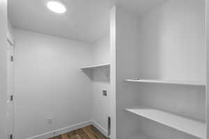 Laundry room featuring dark wood-style floors and washer hookup