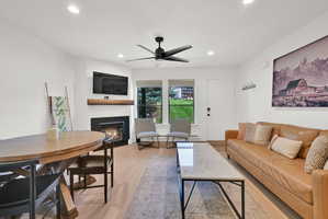 Living room with modern finishes, fireplace, dining area, LVP flooring through-out main level, roman shades.
