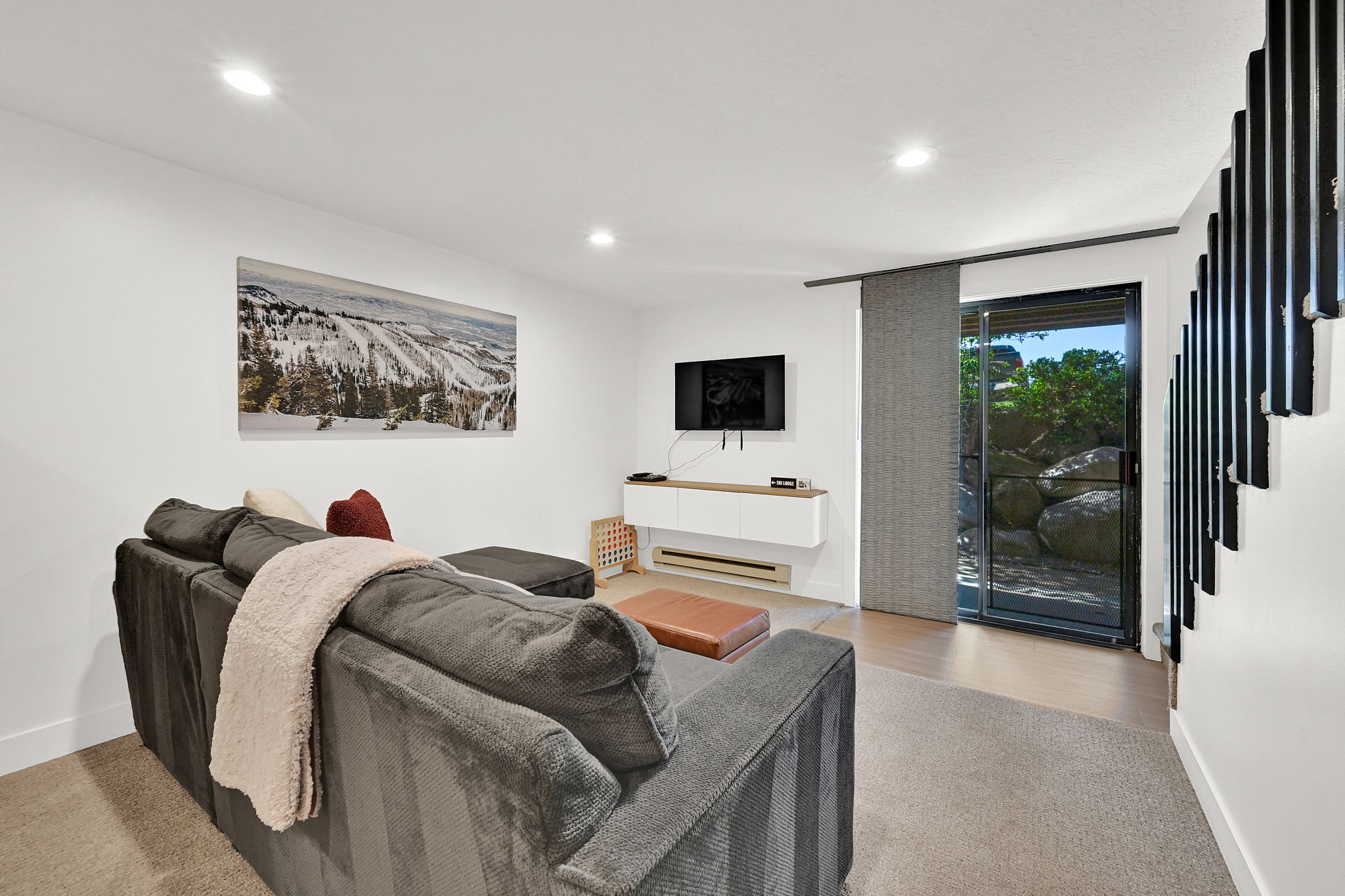 Living room area of the basement with access to patio on main level of the community grounds.