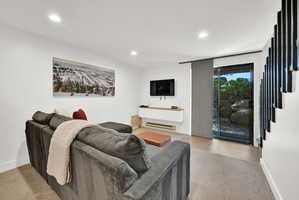 Living room area of the basement with access to patio on main level of the community grounds.