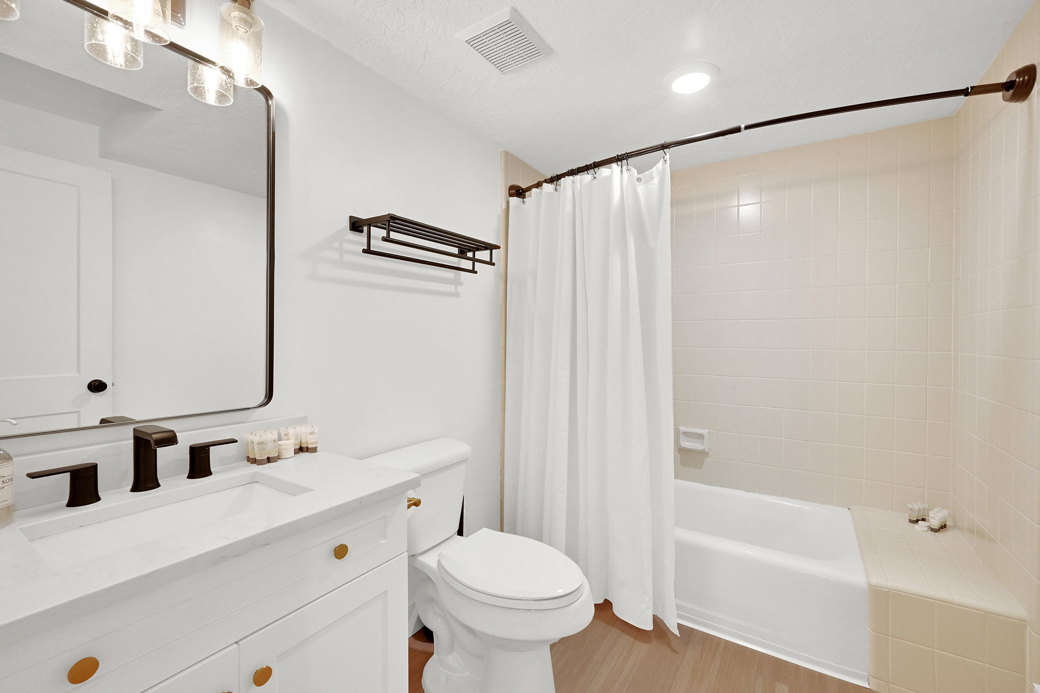 Downstairs full bathroom with tile surround and new vanity.