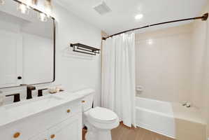 Downstairs full bathroom with tile surround and new vanity.
