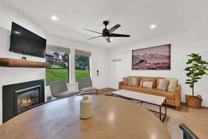 Living room with modern finishes, fireplace, dining area, LVP flooring through-out main level, roman shades.