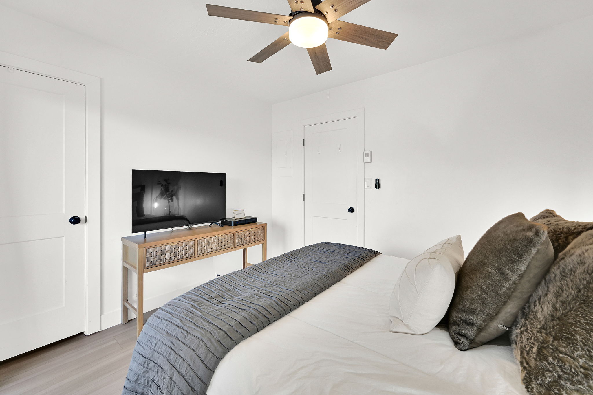 Main floor bedroom #1 with LVP flooring and a private deck.