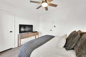 Main floor bedroom #1 with LVP flooring and a private deck.