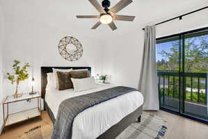 Main floor bedroom #1 with LVP flooring and a private deck.