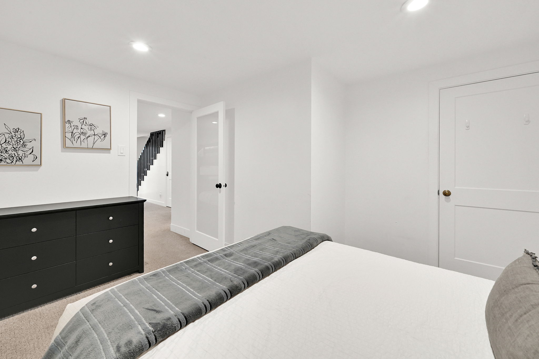 Bedroom #2 with carpet and modern finishes, the door is frosted glass.