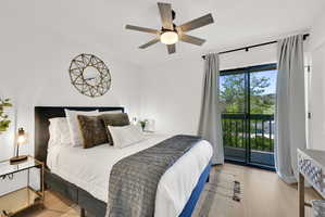 Main floor bedroom #1 with LVP flooring and a private deck.
