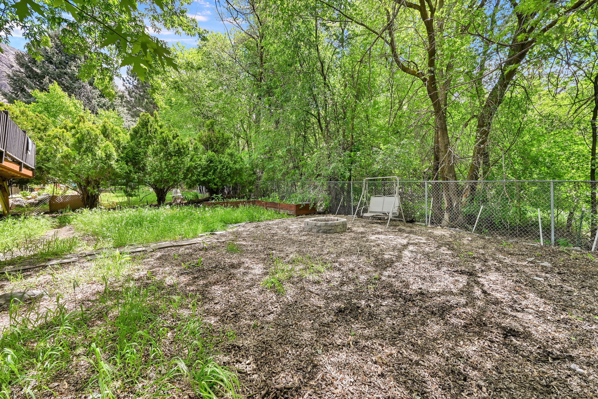 Fenced backyard featuring a fire pit