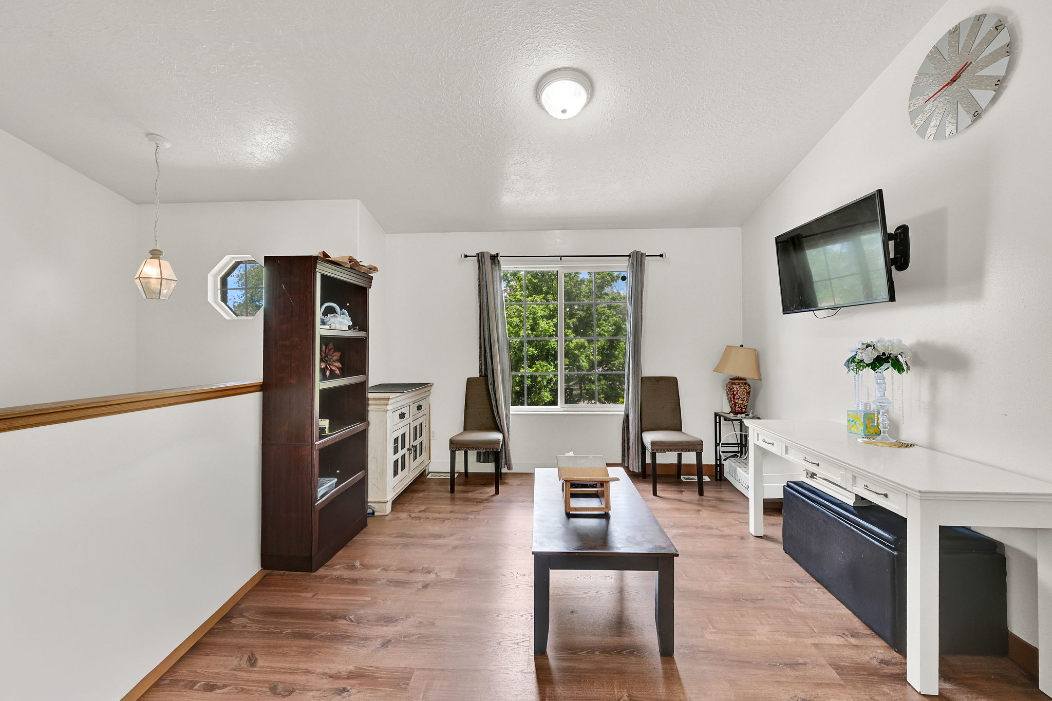Living area featuring light wood finished floors and a textured ceiling