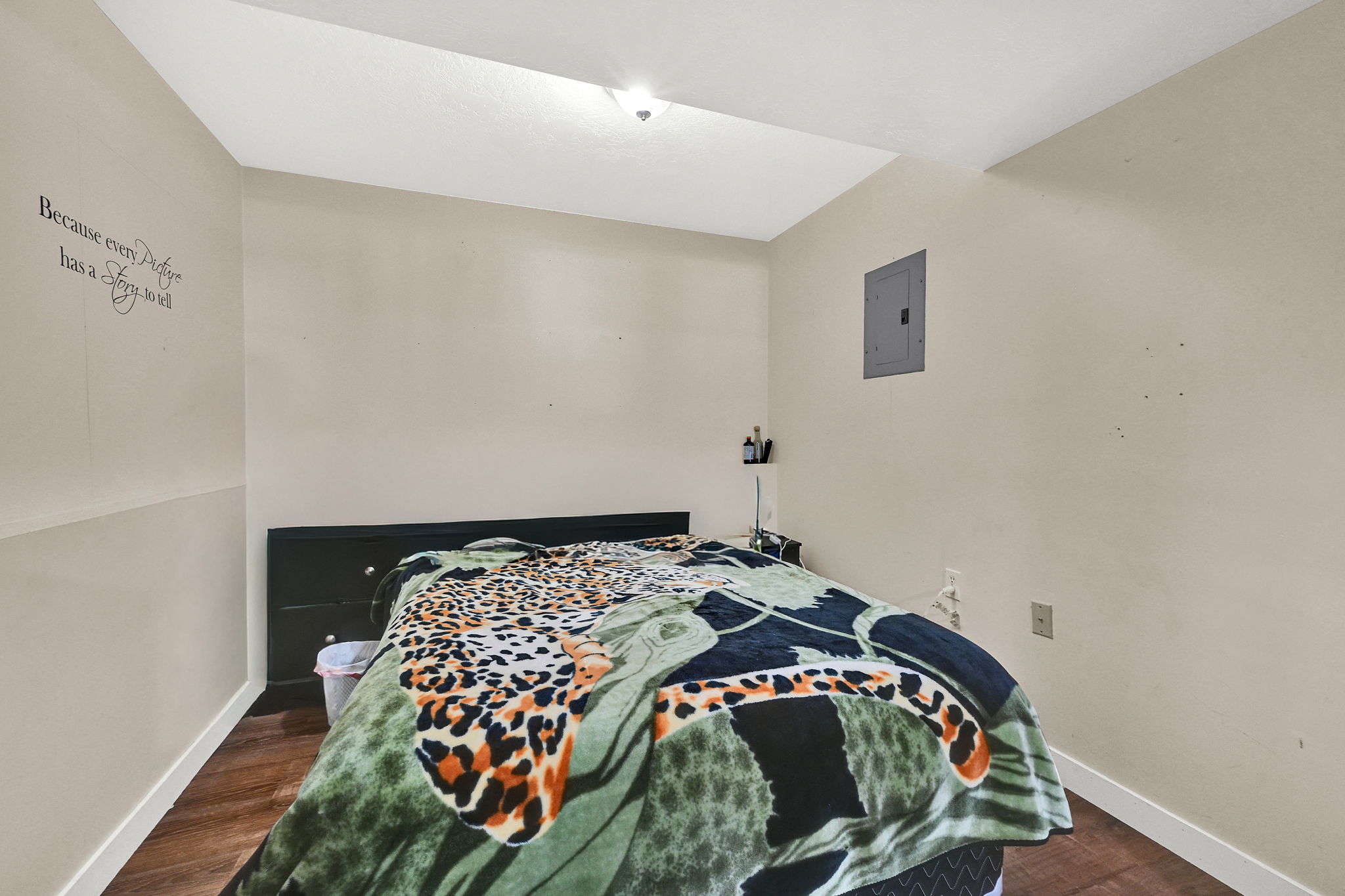 Bedroom featuring dark wood finished floors and electric panel