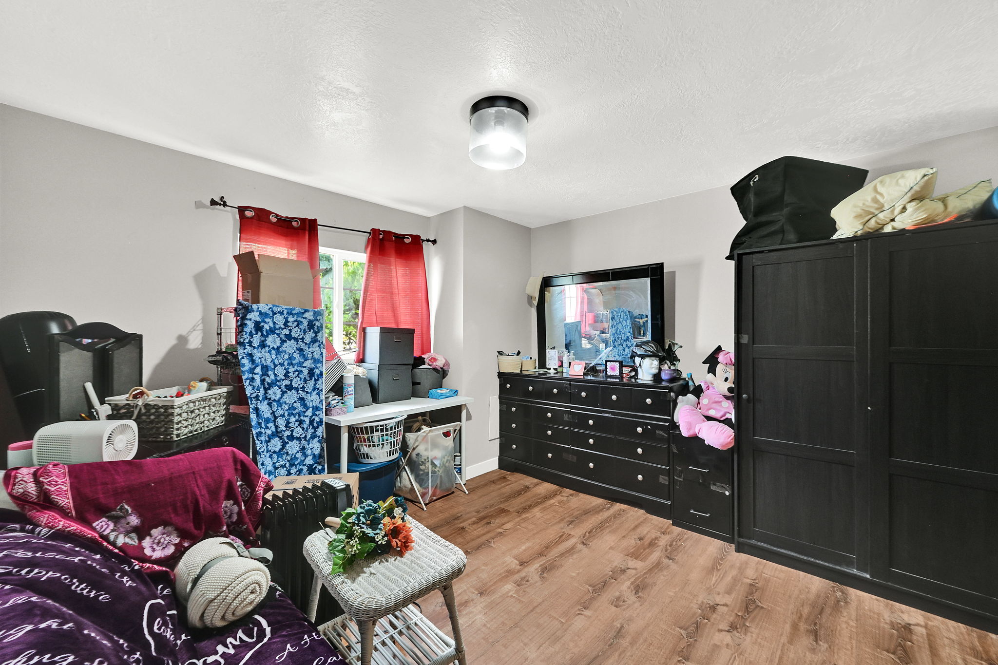 Bedroom featuring light wood finished floors and a textured ceiling