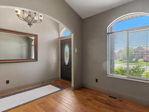 Entryway featuring rich wood-finish flooring with a decorative tile inlay