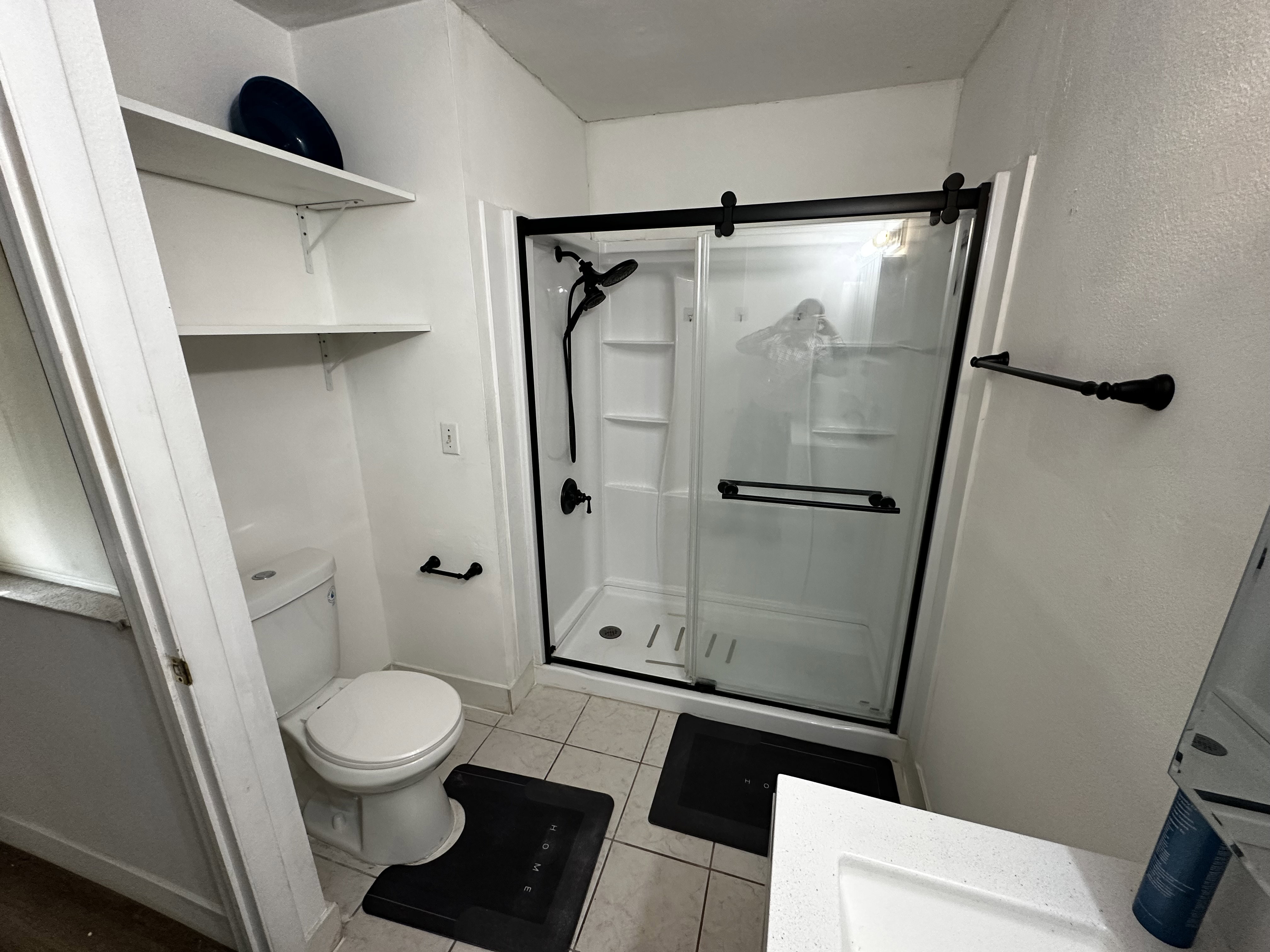 Updated bathroom with walk-in shower, modern fixtures, and clean finishes.