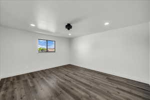 Spare room with dark wood finished floors and recessed lighting