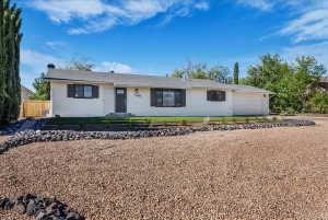 Ranch-style house featuring a garage and concrete driveway