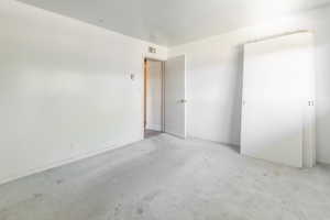Unfurnished bedroom featuring carpet and baseboards