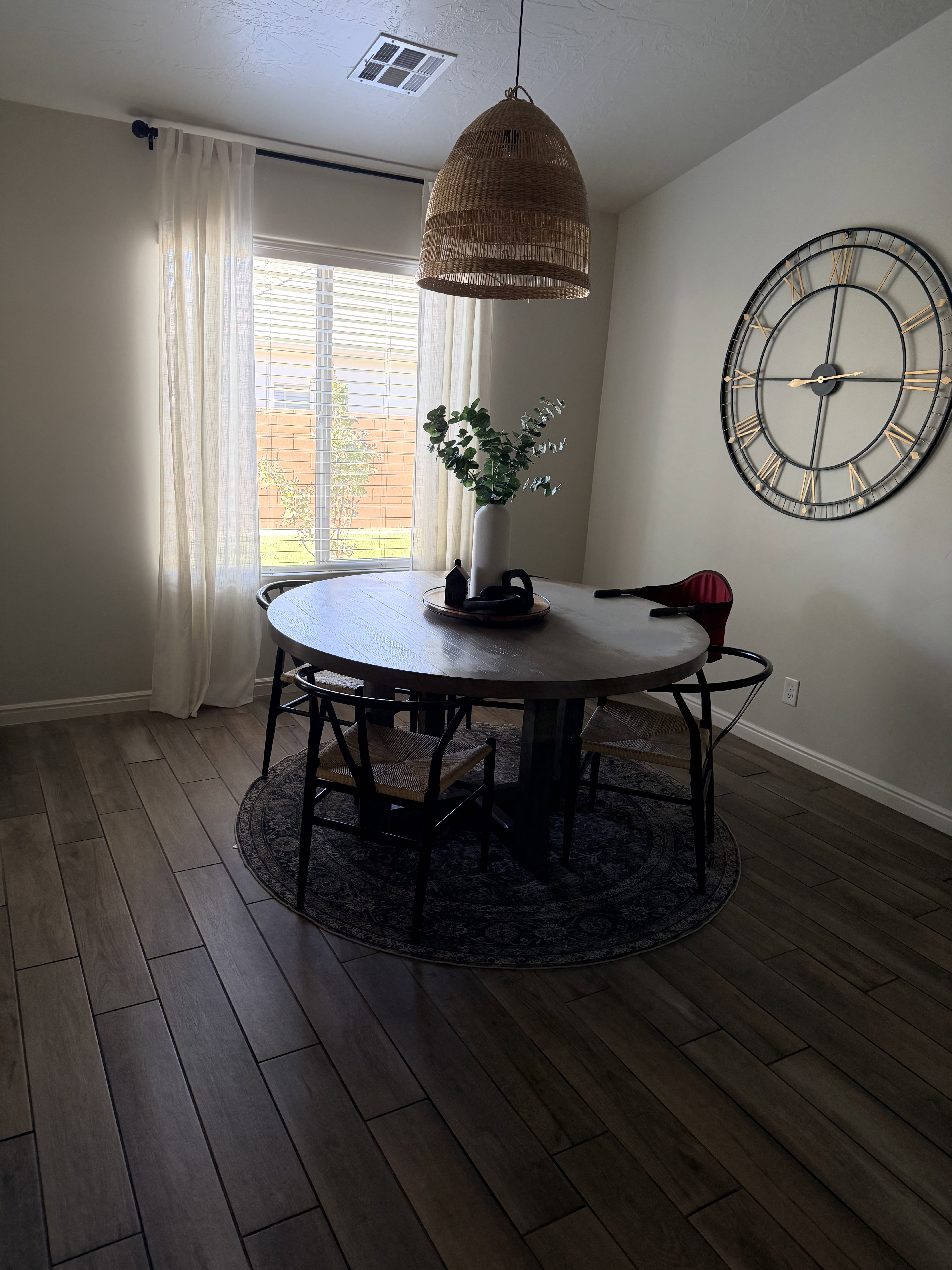Dining area with baseboards and dark wood-style flooring