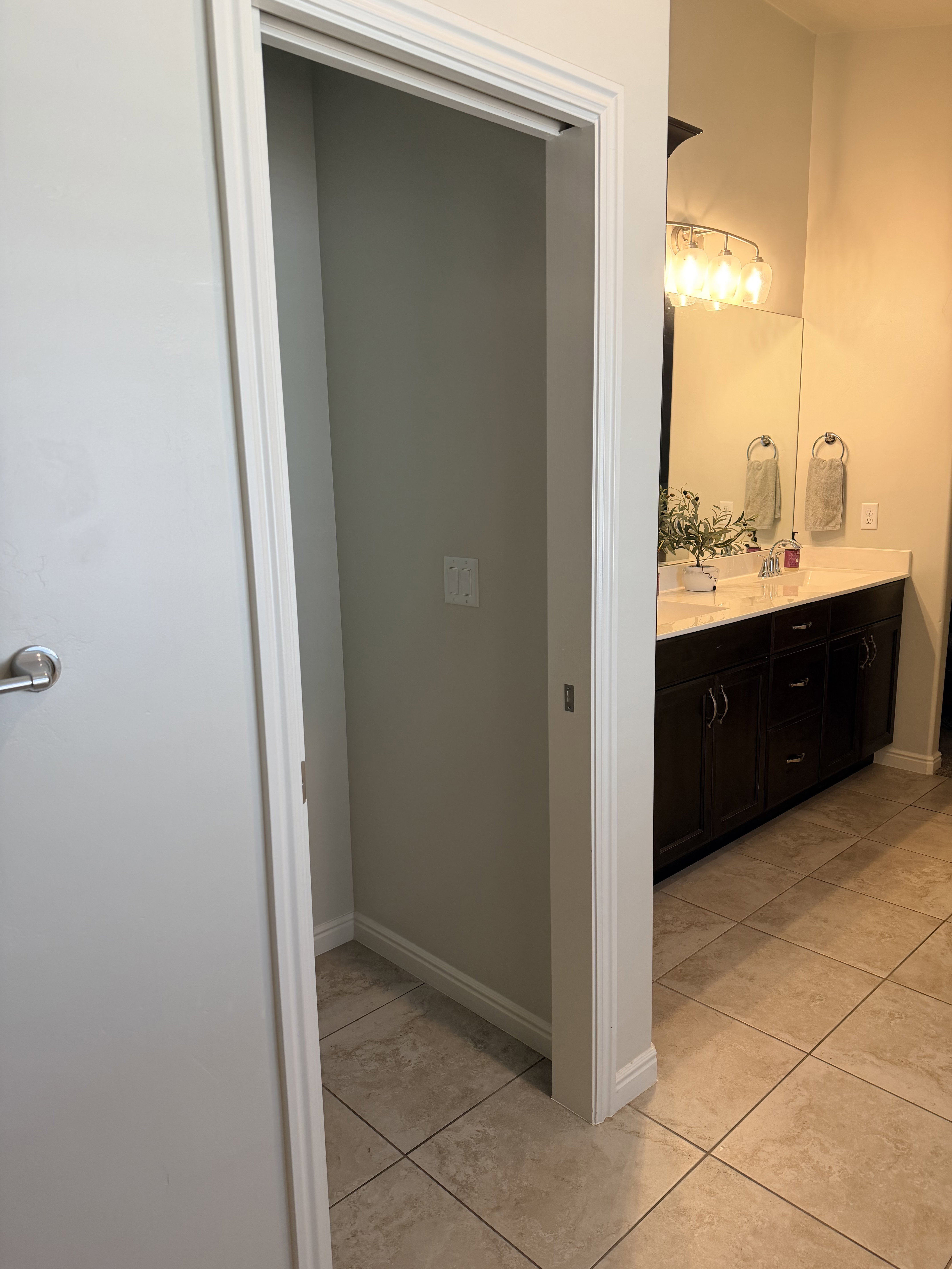 Bathroom featuring double vanity and light tile patterned floors