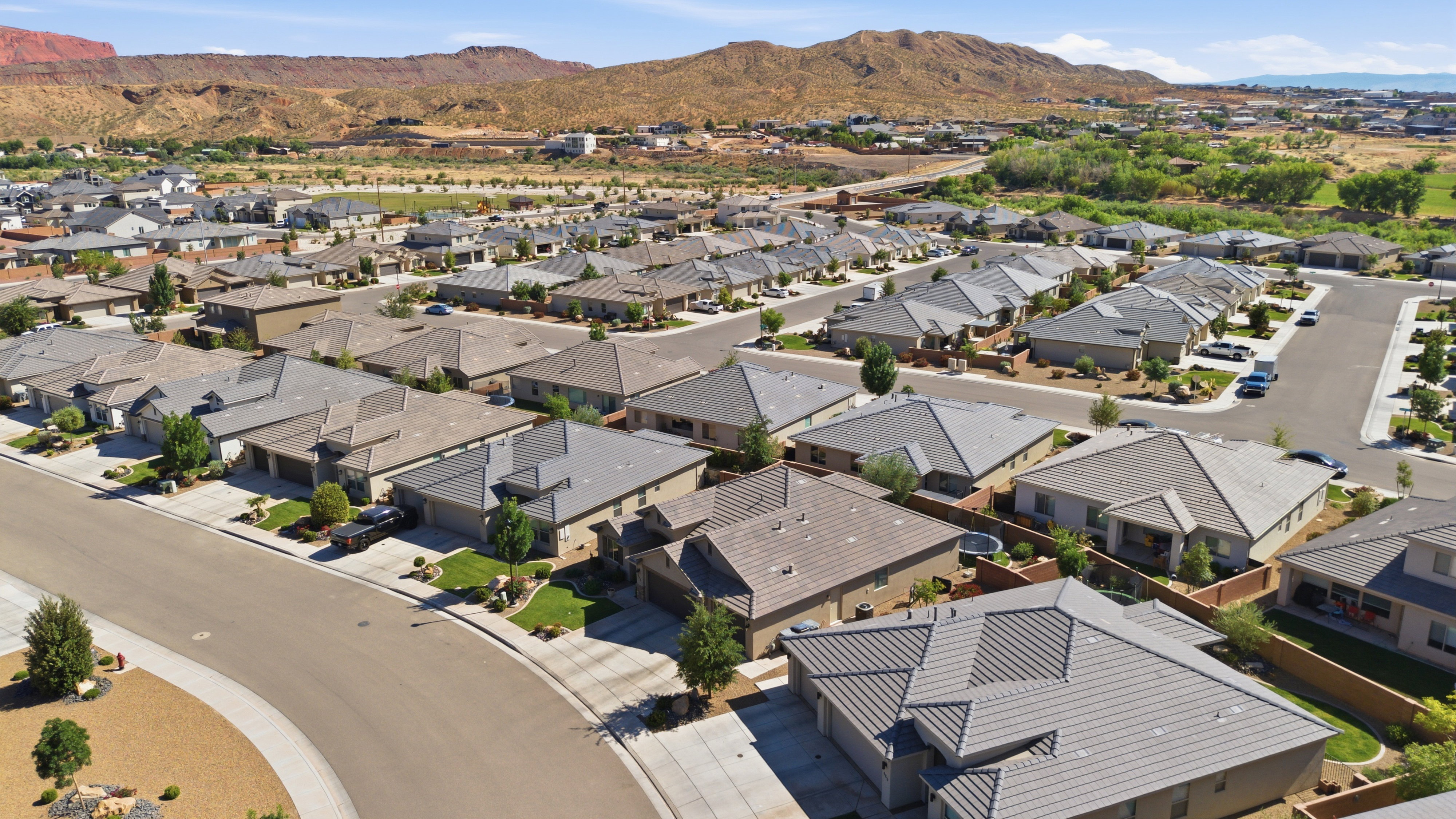 Residential community featuring numerous single-story homes, paved streets, and varied landscaping