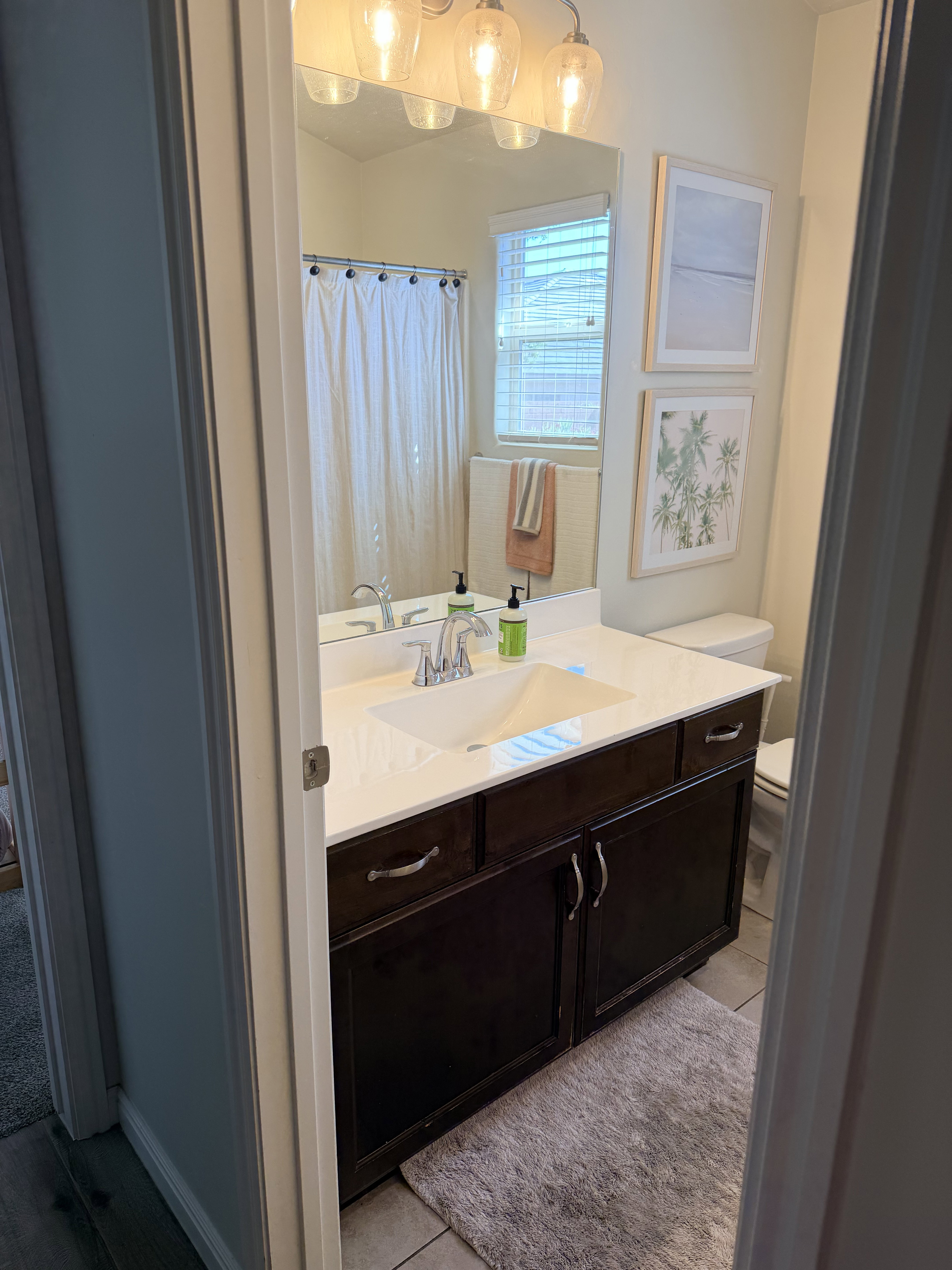Full bath with vanity, a shower with shower curtain, and light tile patterned flooring