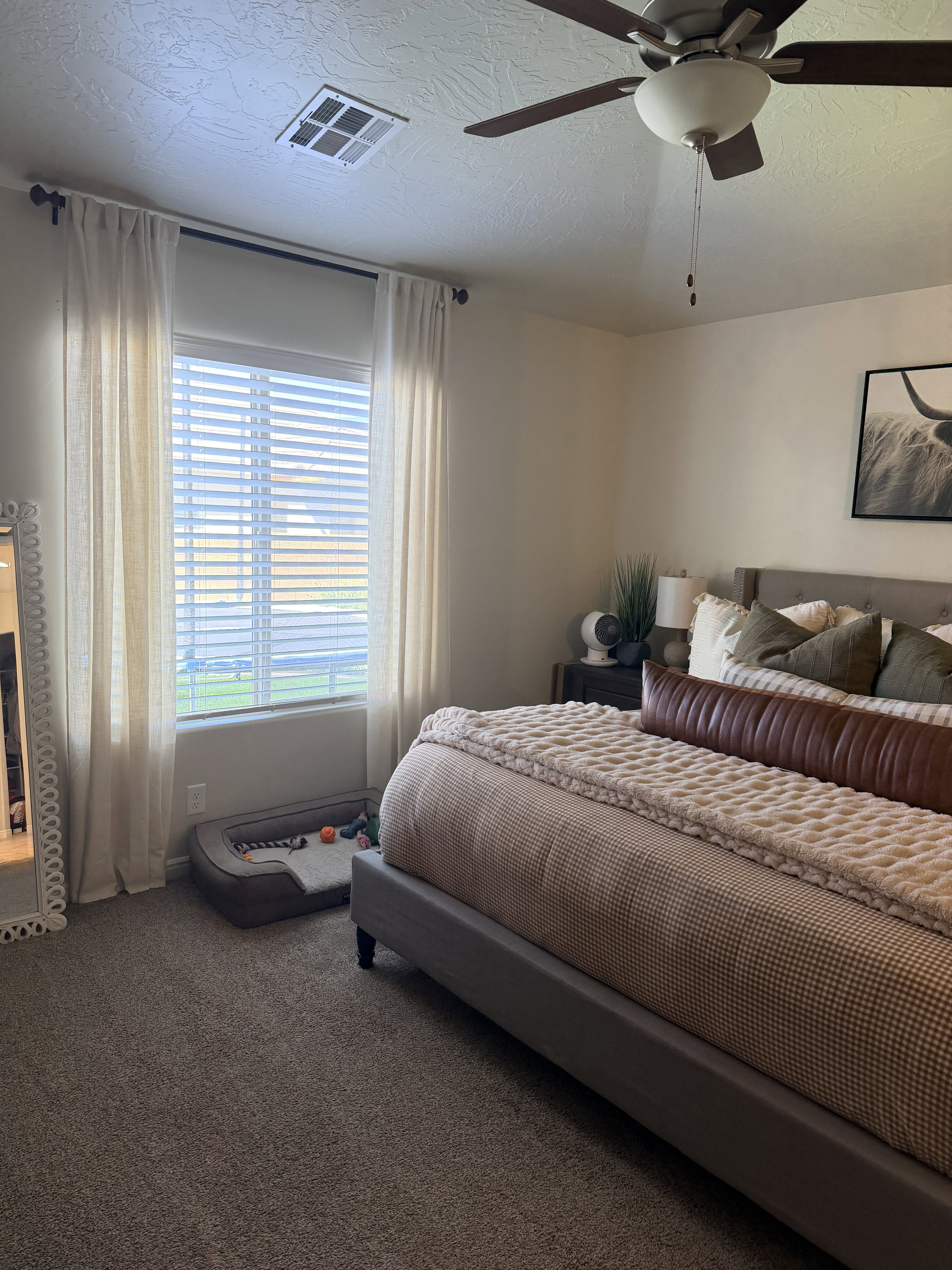Carpeted bedroom featuring a textured ceiling and ceiling fan