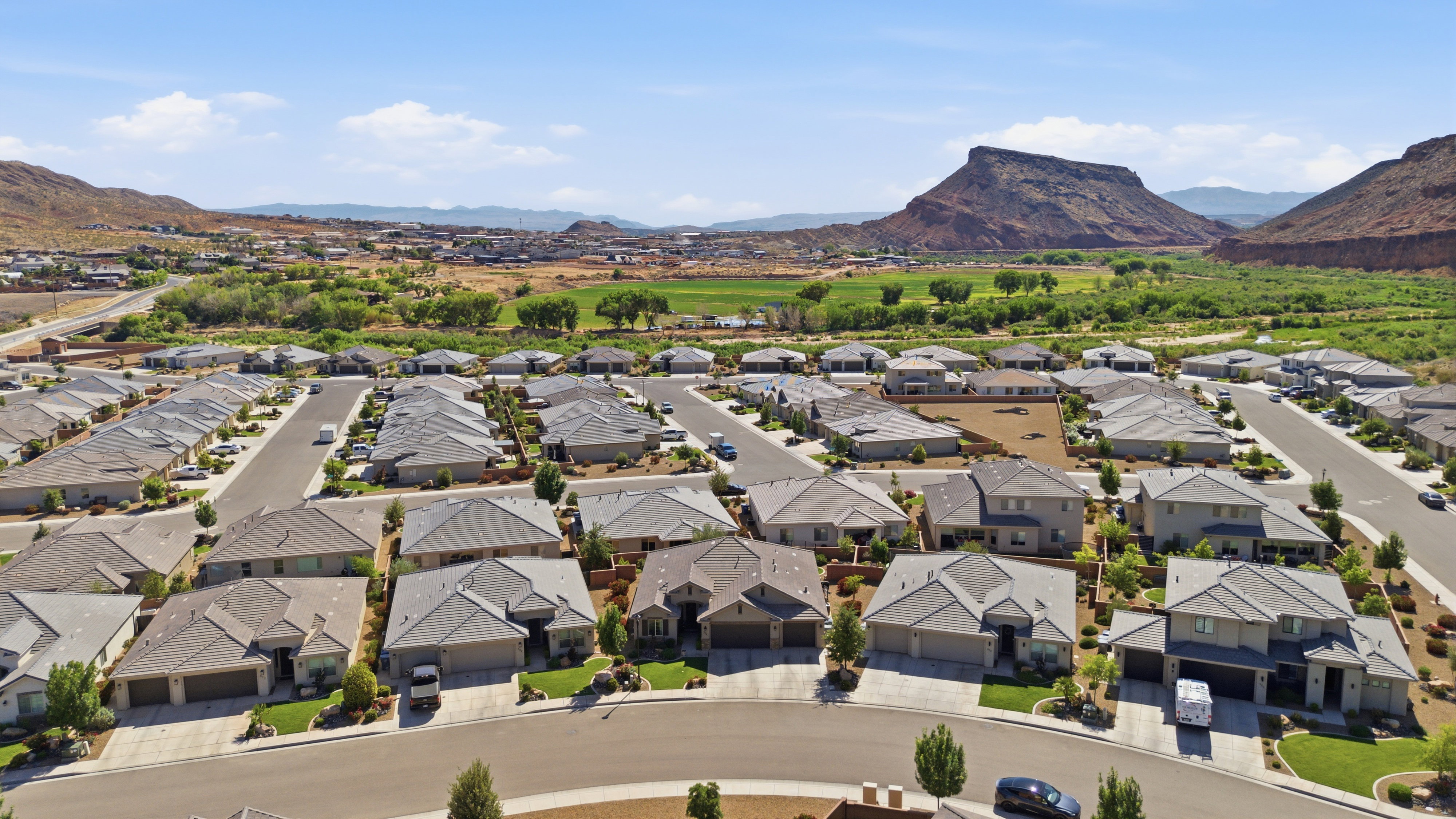 Residential neighborhood featuring multiple single-family homes with pitched roofs and attached garages