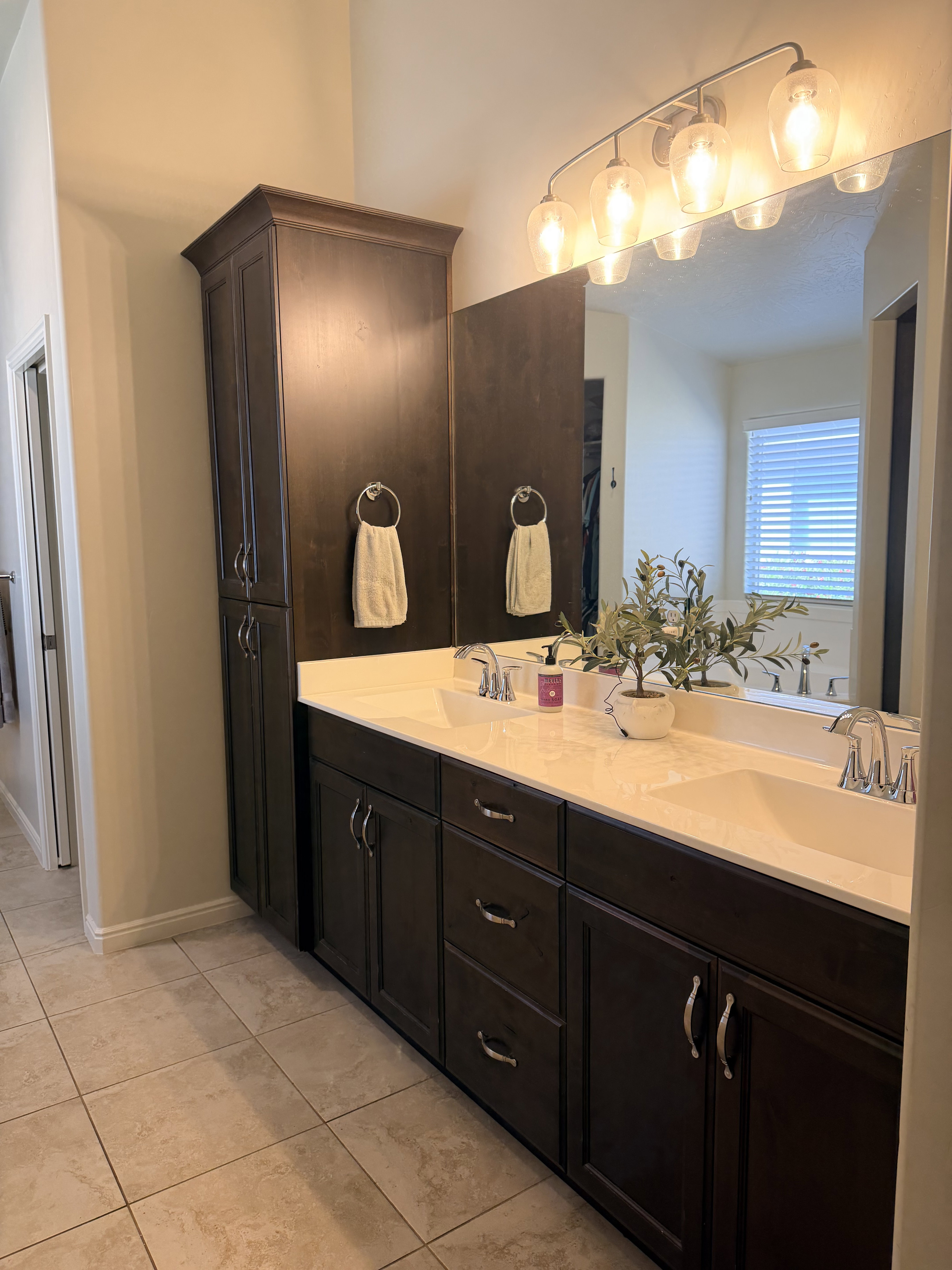 Bathroom featuring double vanity and baseboards