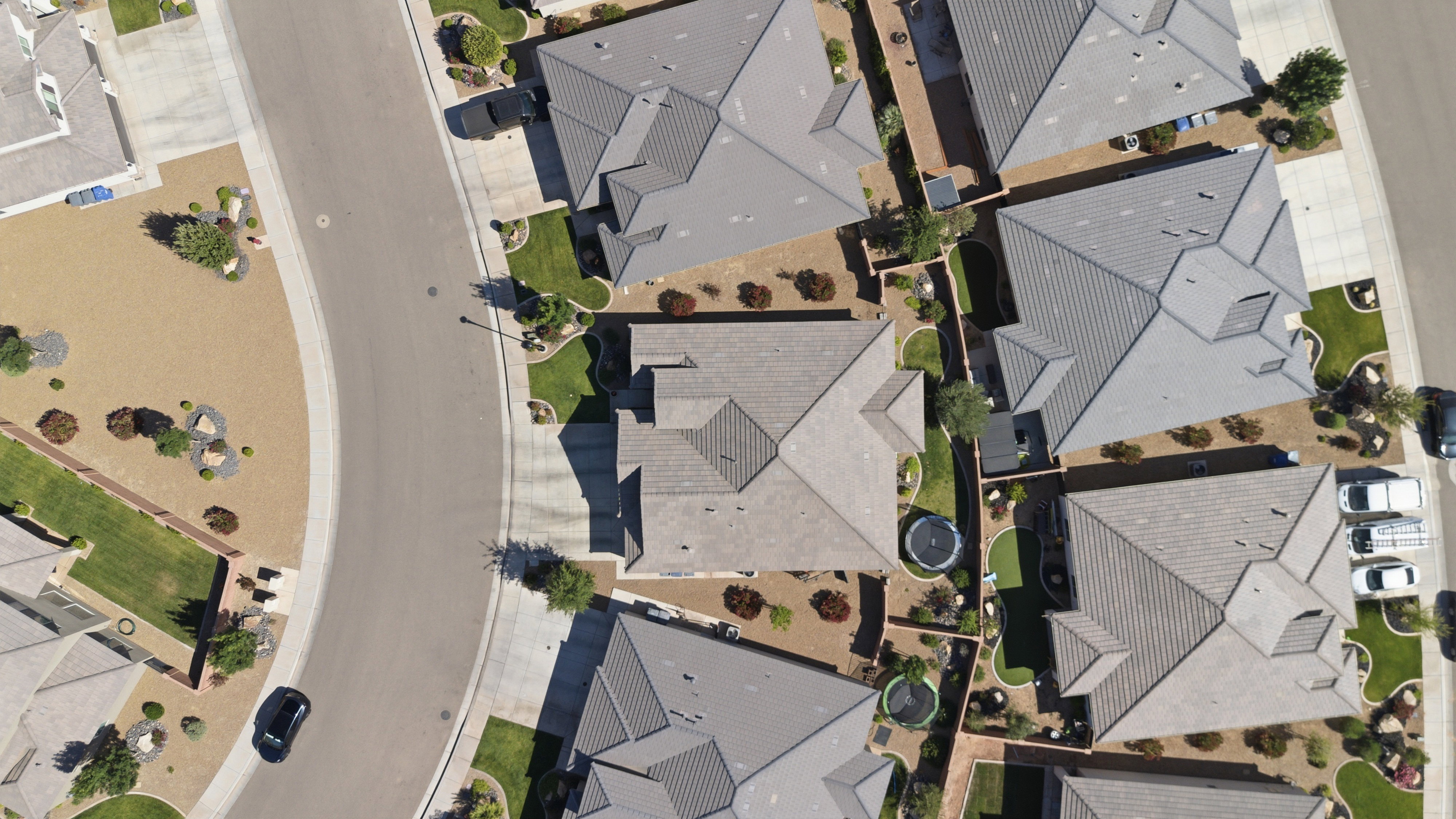 Residential community featuring uniformly designed homes with gray shingle roofs