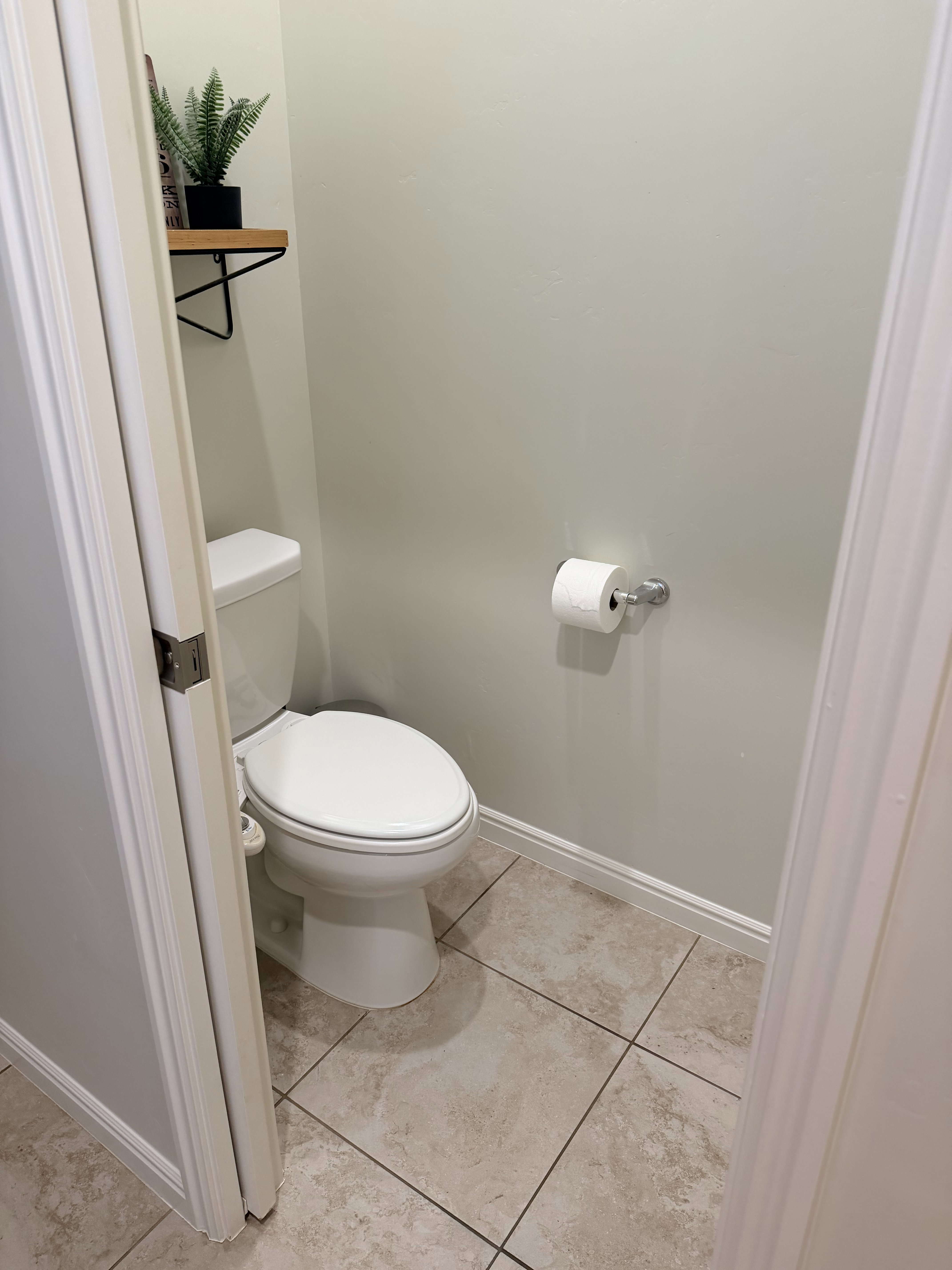 Bathroom featuring baseboards and light tile patterned flooring