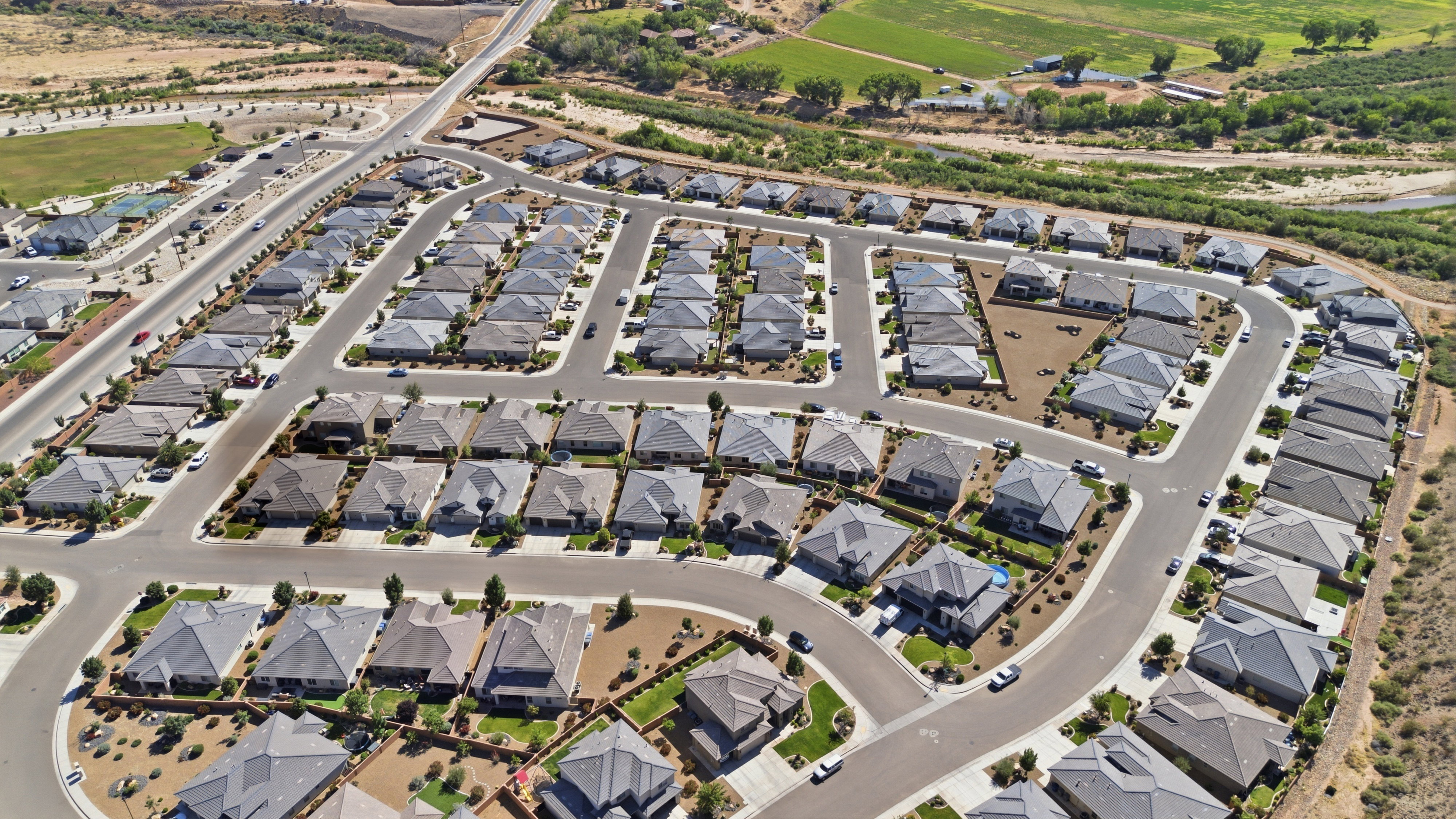 Expansive aerial perspective showcasing a residential development with multiple single-family homes