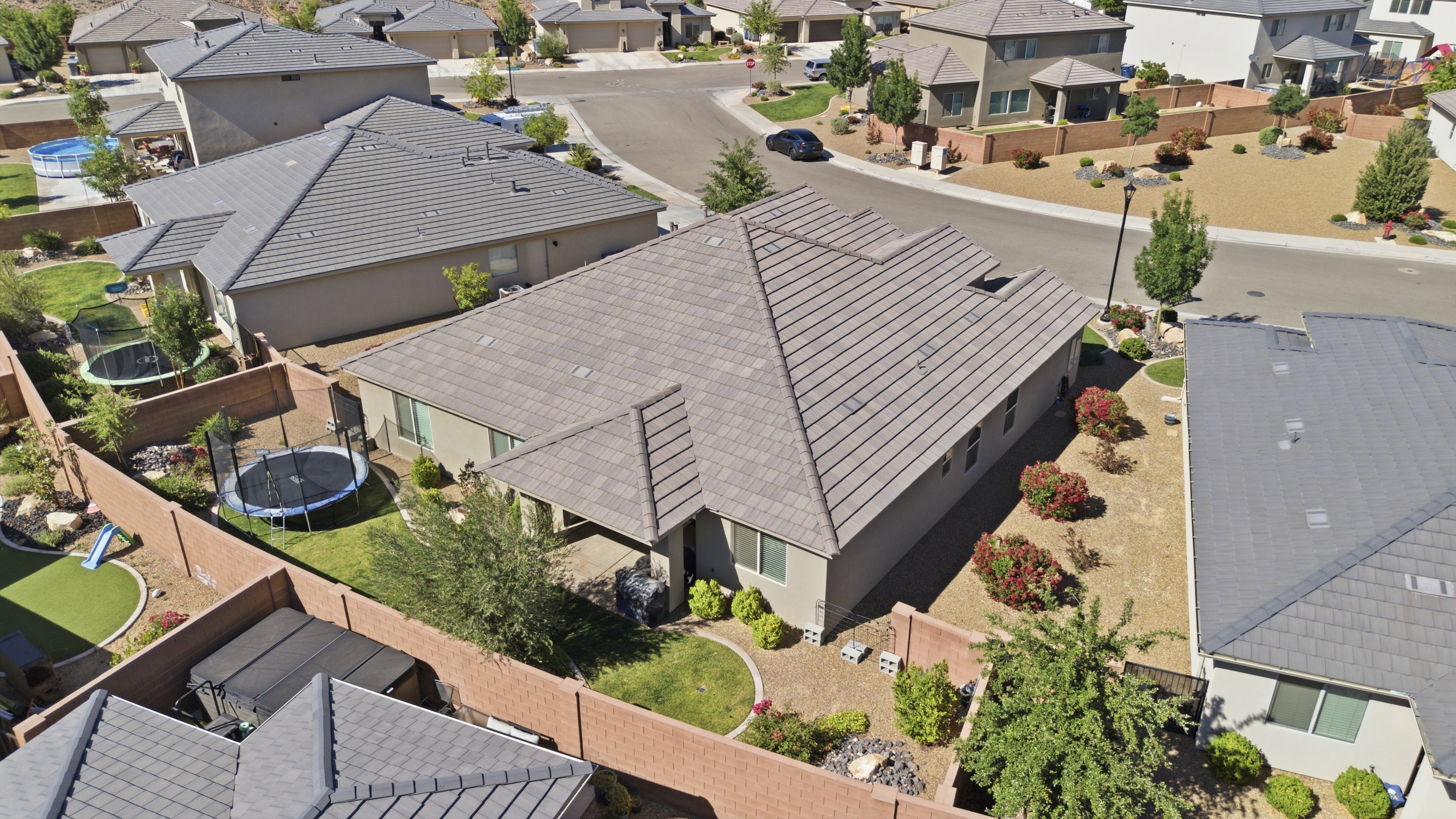 Aerial perspective showcasing a property with a distinct, multi-pitched tile roof