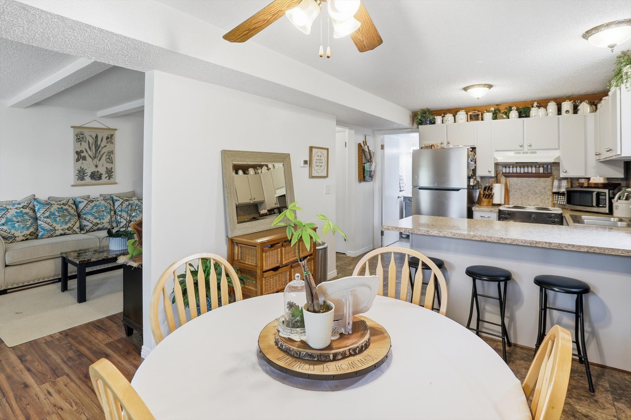 Dining room with a ceiling fan and dark wood finished floors