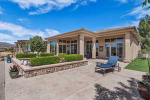 Back of house featuring a patio, stucco siding, and a tile roof