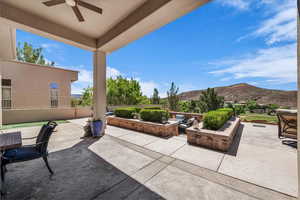 View of patio / terrace with a mountain view and ceiling fan