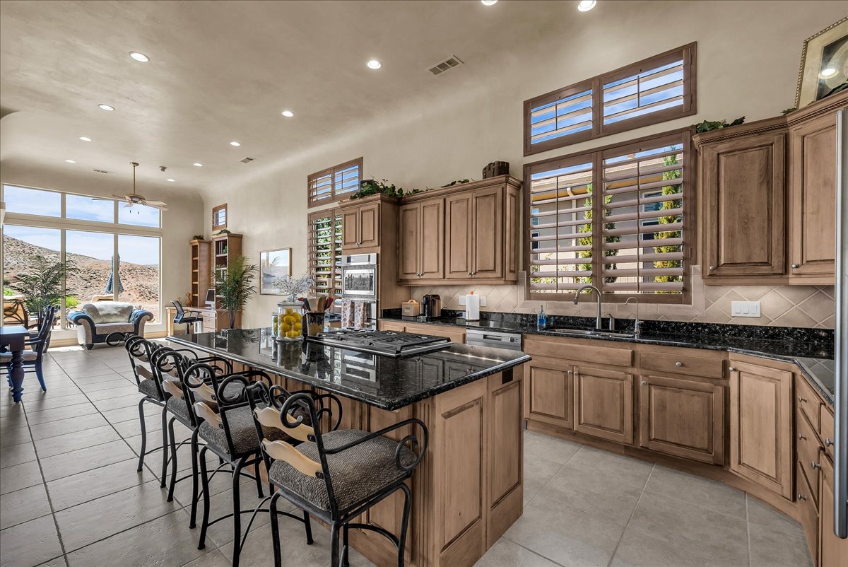 Kitchen with a center island, a breakfast bar area, recessed lighting, dark stone counters, and a mountain view