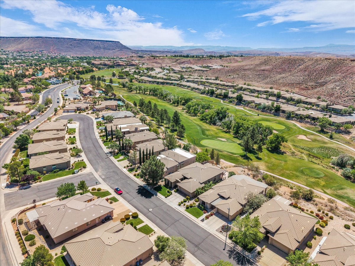 Aerial perspective of suburban area featuring mountains and a local golf course