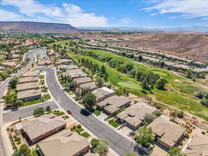 Aerial perspective of suburban area featuring mountains and a local golf course