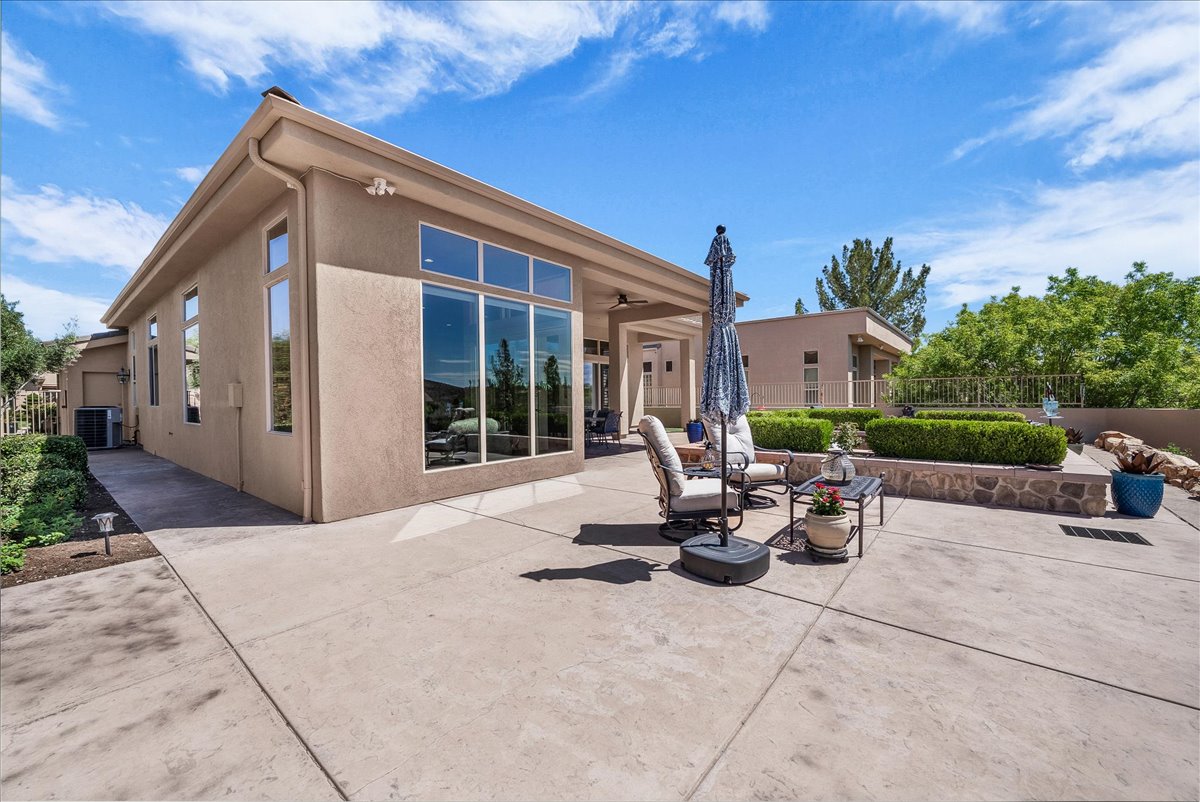 Rear view of house with stucco siding and a patio area