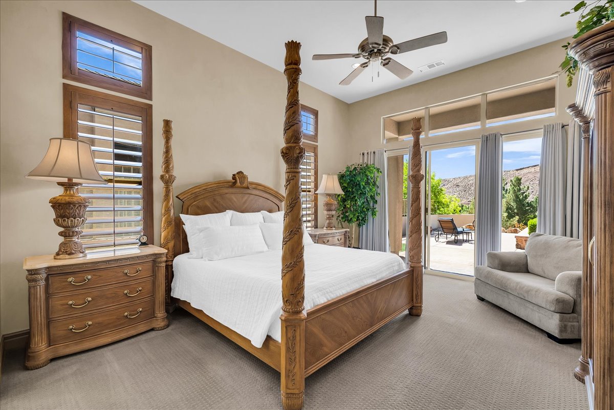 Carpeted bedroom with access to outside, ceiling fan, and a mountain view