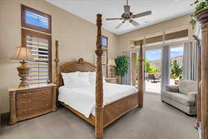 Carpeted bedroom with access to outside, ceiling fan, and a mountain view