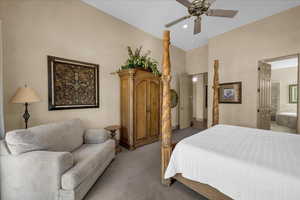 Carpeted bedroom with ceiling fan, ensuite bath, and recessed lighting