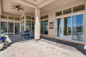 View of patio with outdoor dining area and a ceiling fan