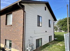 View of side of home featuring brick siding
